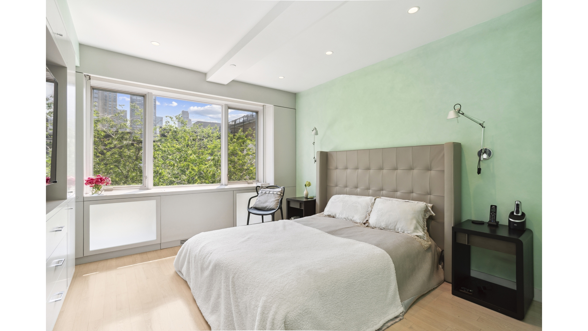 435 East 76th Street, Unit 6A Manhattan, NY 10021 - Photo 6 of 13 a bedroom with a large bed and a large window