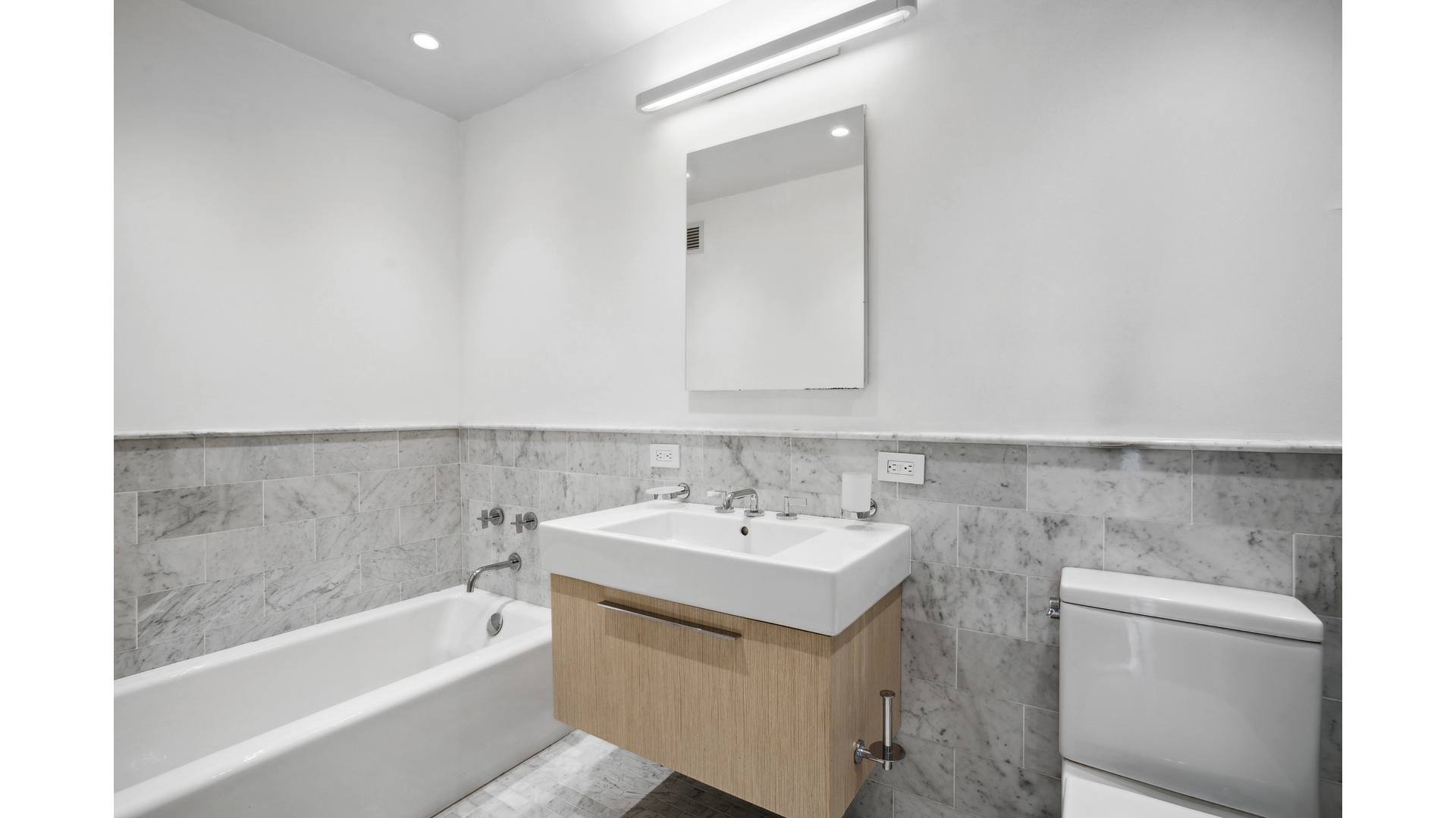 435 East 76th Street, Unit 6A Manhattan, NY 10021 - Photo 7 of 13 a bathroom with a sink a toilet and bathtub