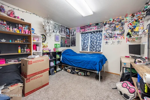 a living room with furniture and a baby crib