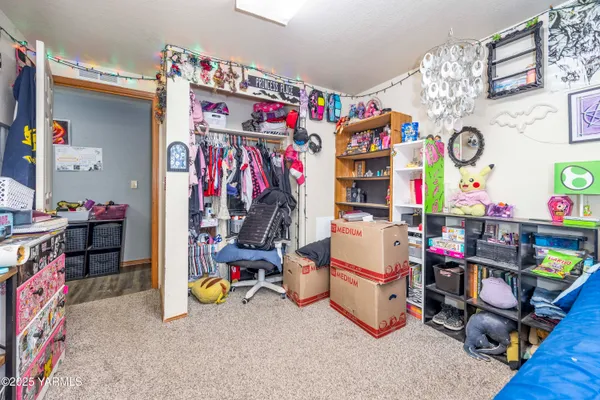 a spacious bedroom with a bed and large windows