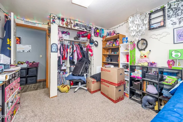 a spacious bedroom with a bed and large windows