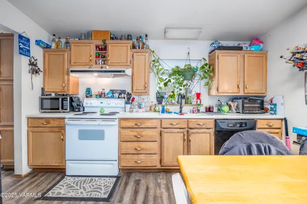 a kitchen with a refrigerator and white cabinets