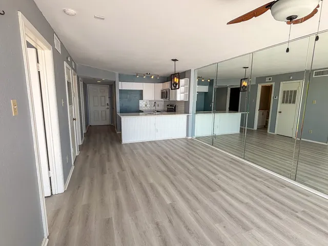 a view of a room with wooden floor