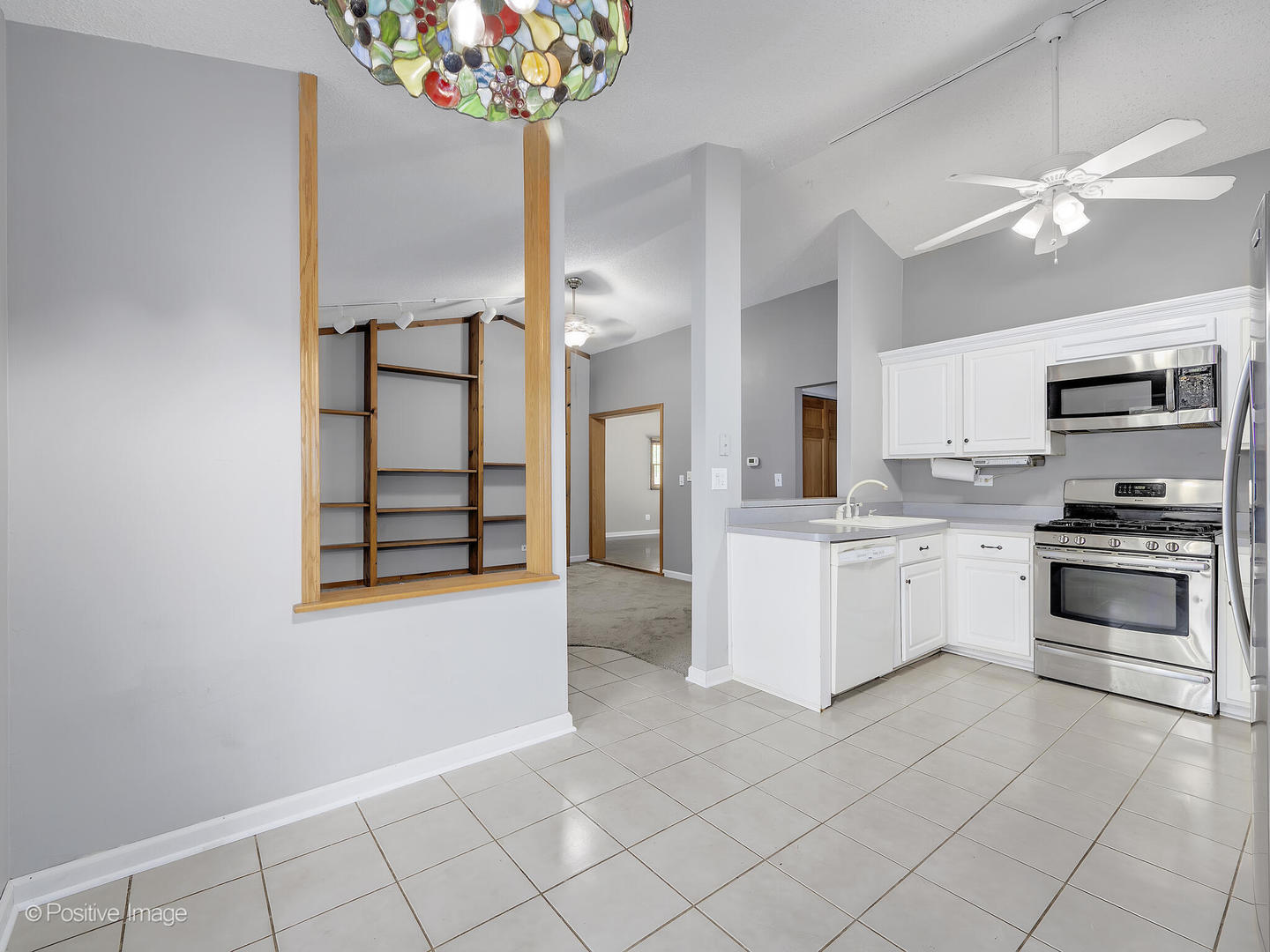 1985 Navarone Drive Naperville, IL 60565 - Photo 12 of 24 a kitchen with granite countertop white cabinets and stainless steel appliances