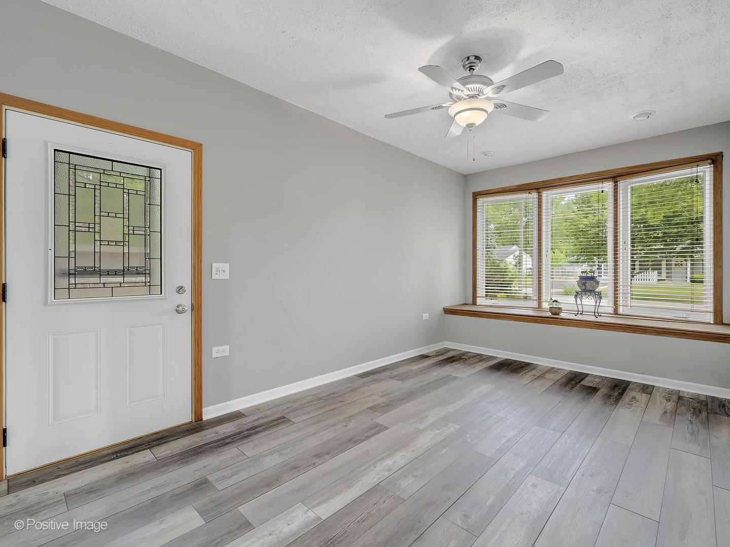 1985 Navarone Drive Naperville, IL 60565 - Photo 14 of 24 a view of an empty room with wooden floor and a window