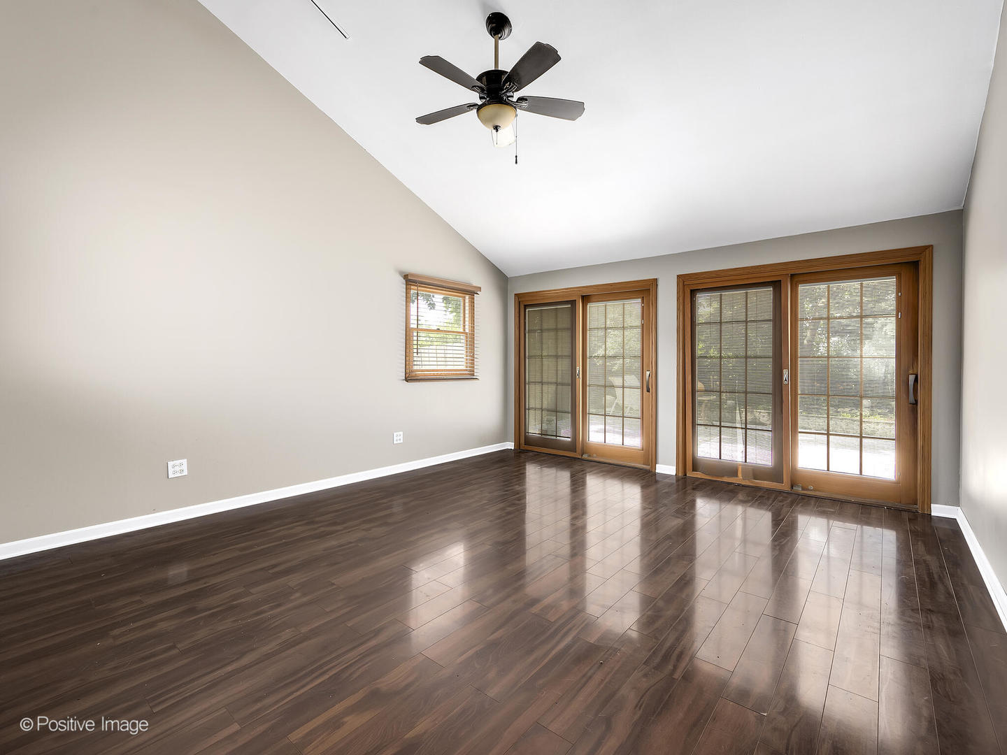 1985 Navarone Drive Naperville, IL 60565 - Photo 7 of 24 a view of an empty room with a window and wooden floor
