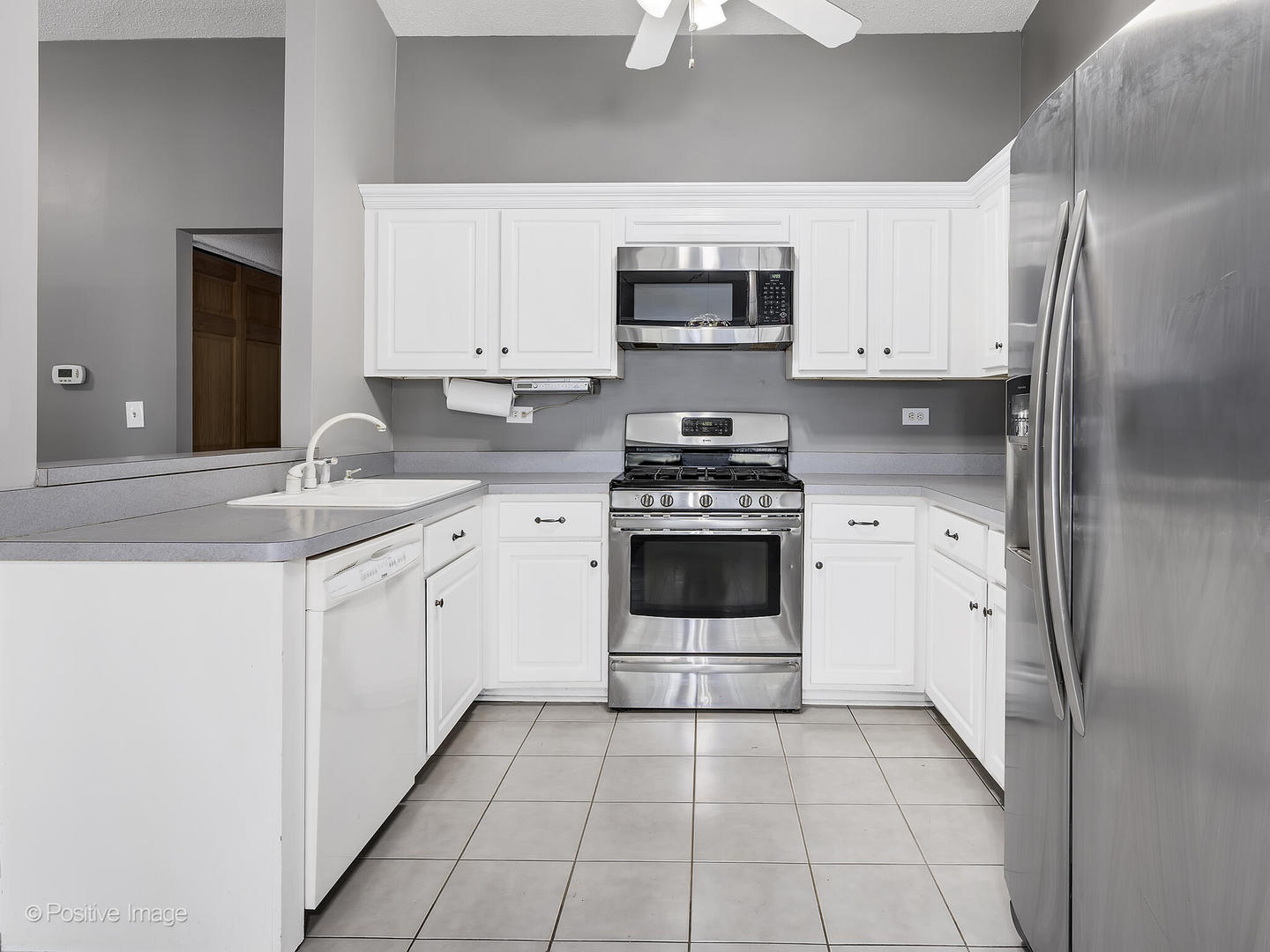 1985 Navarone Drive Naperville, IL 60565 - Photo 9 of 24 a kitchen with stainless steel appliances granite countertop a stove a sink and a microwave