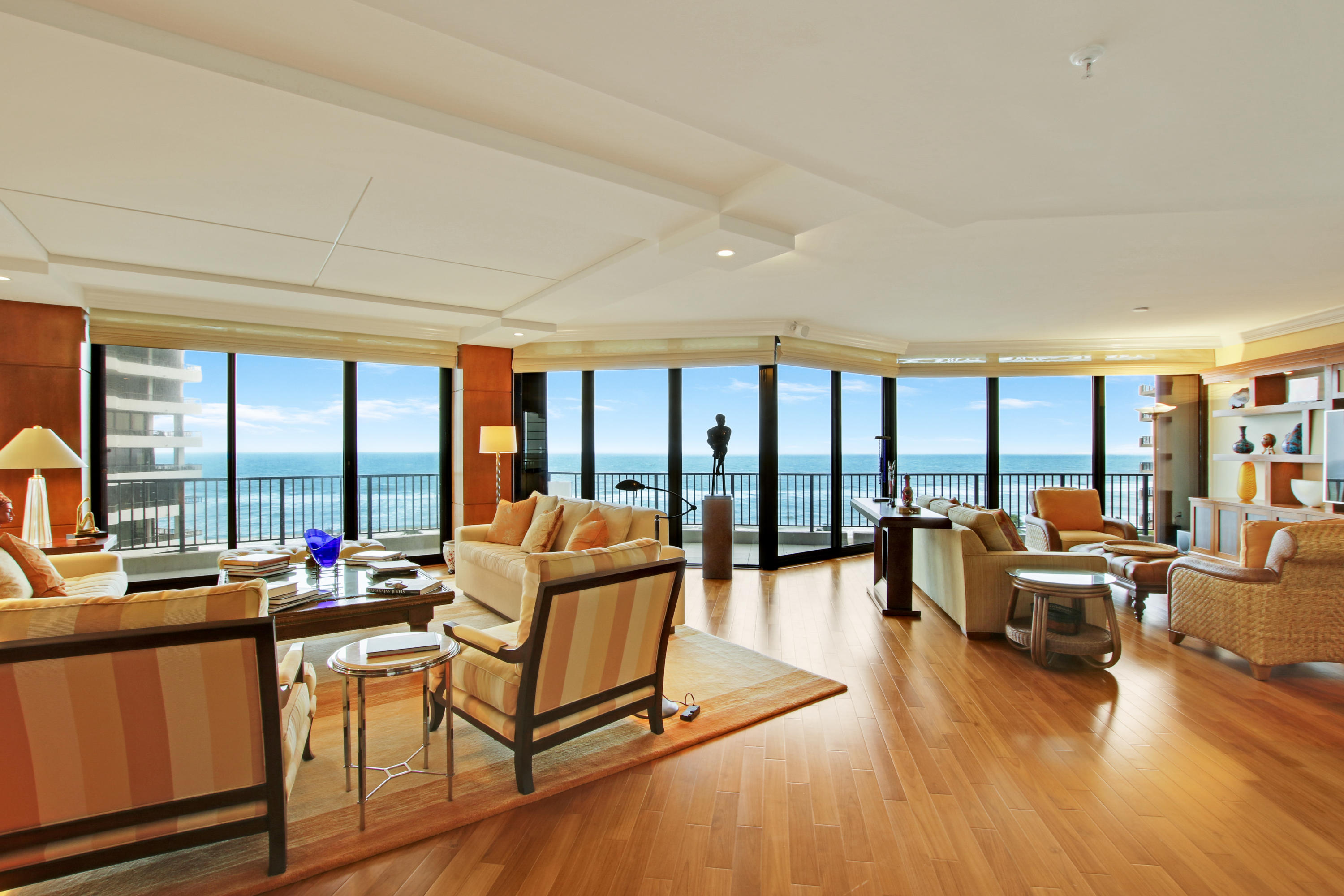 a living room with furniture and floor to ceiling windows