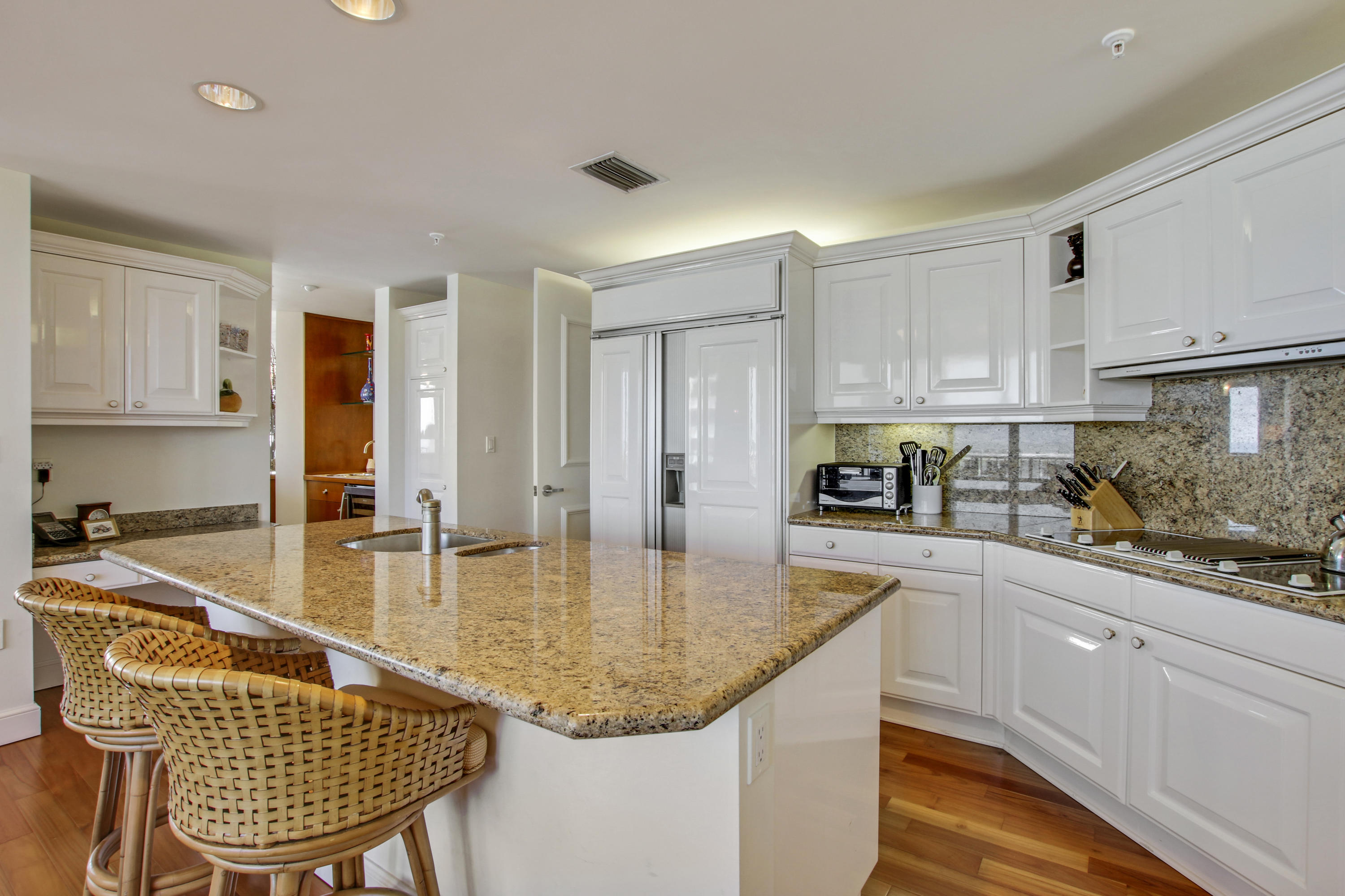 570 Ocean Drive, Unit 601 Juno Beach, FL 33408 - Photo 13 of 35 a kitchen with granite countertop kitchen island stainless steel appliances a sink and cabinets