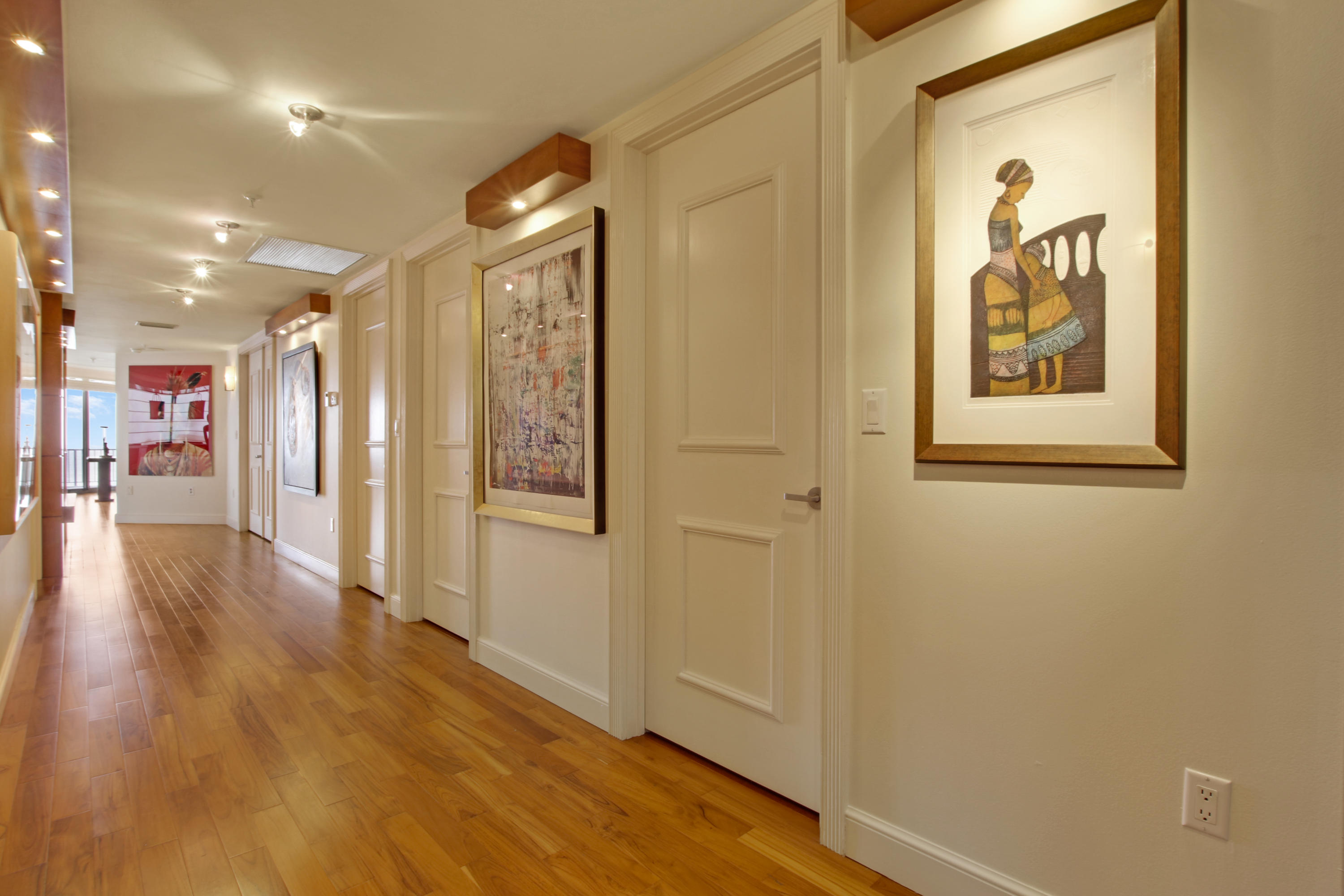 570 Ocean Drive, Unit 601 Juno Beach, FL 33408 - Photo 15 of 35 a view of a hallway with wooden floor