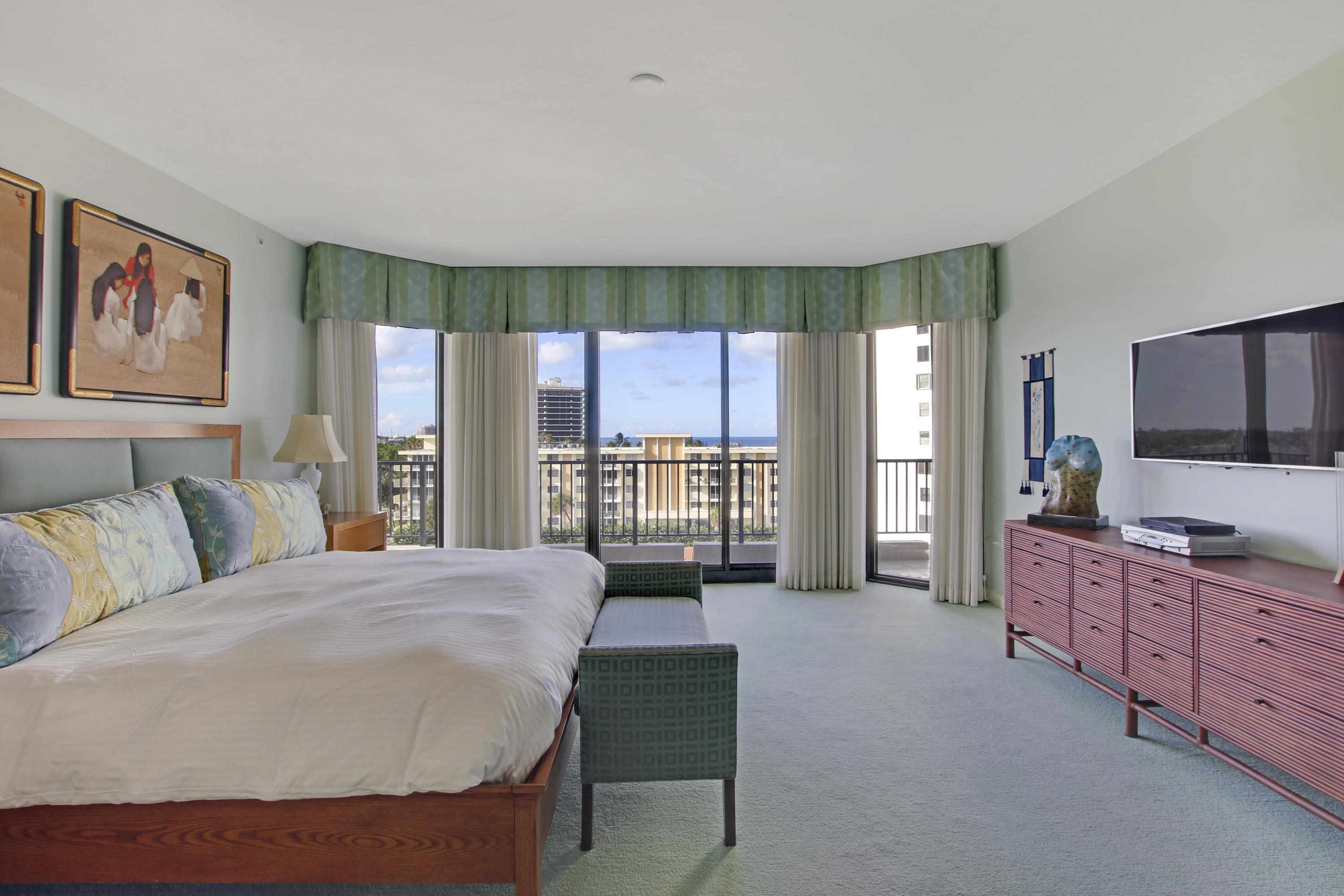 570 Ocean Drive, Unit 601 Juno Beach, FL 33408 - Photo 17 of 35 a spacious bedroom with a large bed and a flat screen tv