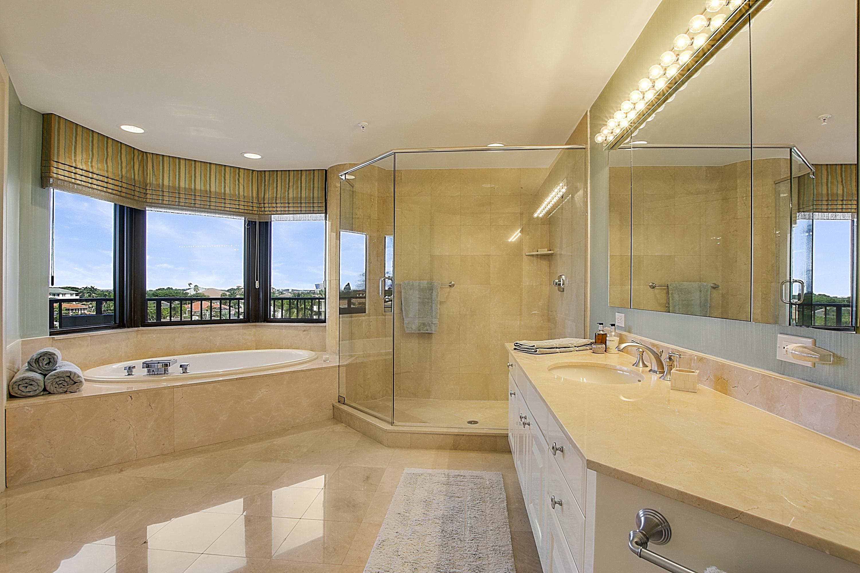 570 Ocean Drive, Unit 601 Juno Beach, FL 33408 - Photo 18 of 35 a spacious bathroom with a large tub and sink