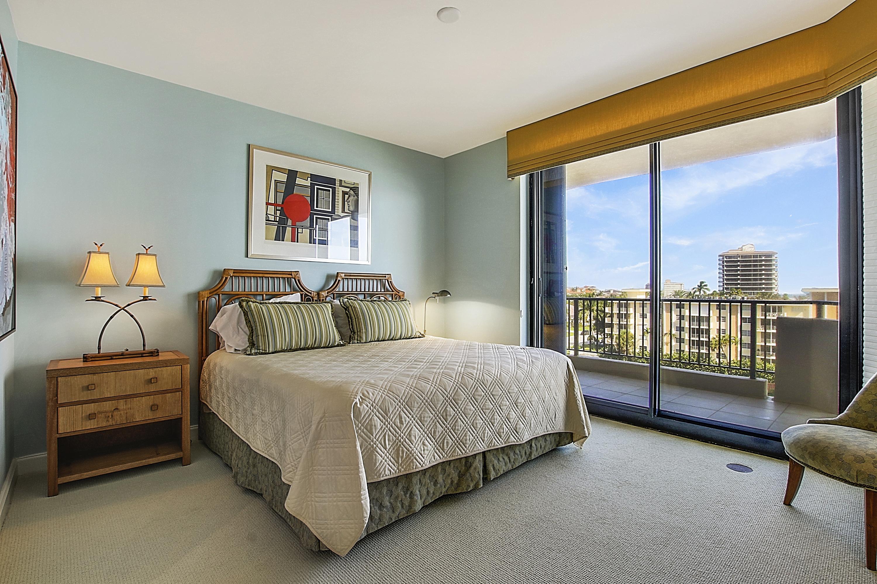 570 Ocean Drive, Unit 601 Juno Beach, FL 33408 - Photo 20 of 35 a bedroom with a bed and glass door