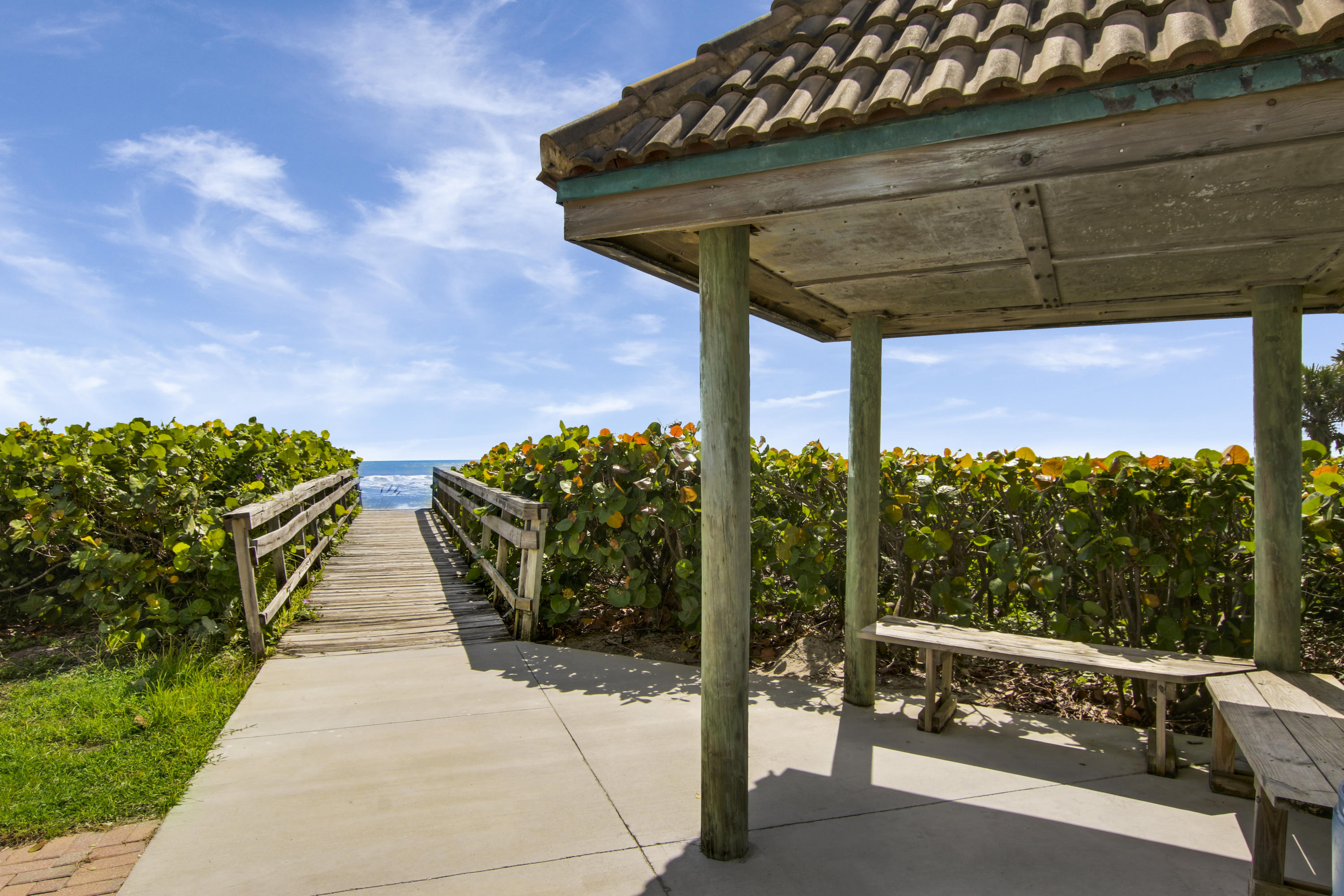 570 Ocean Drive, Unit 601 Juno Beach, FL 33408 - Photo 4 of 35 a view of a patio with table and chairs potted plants
