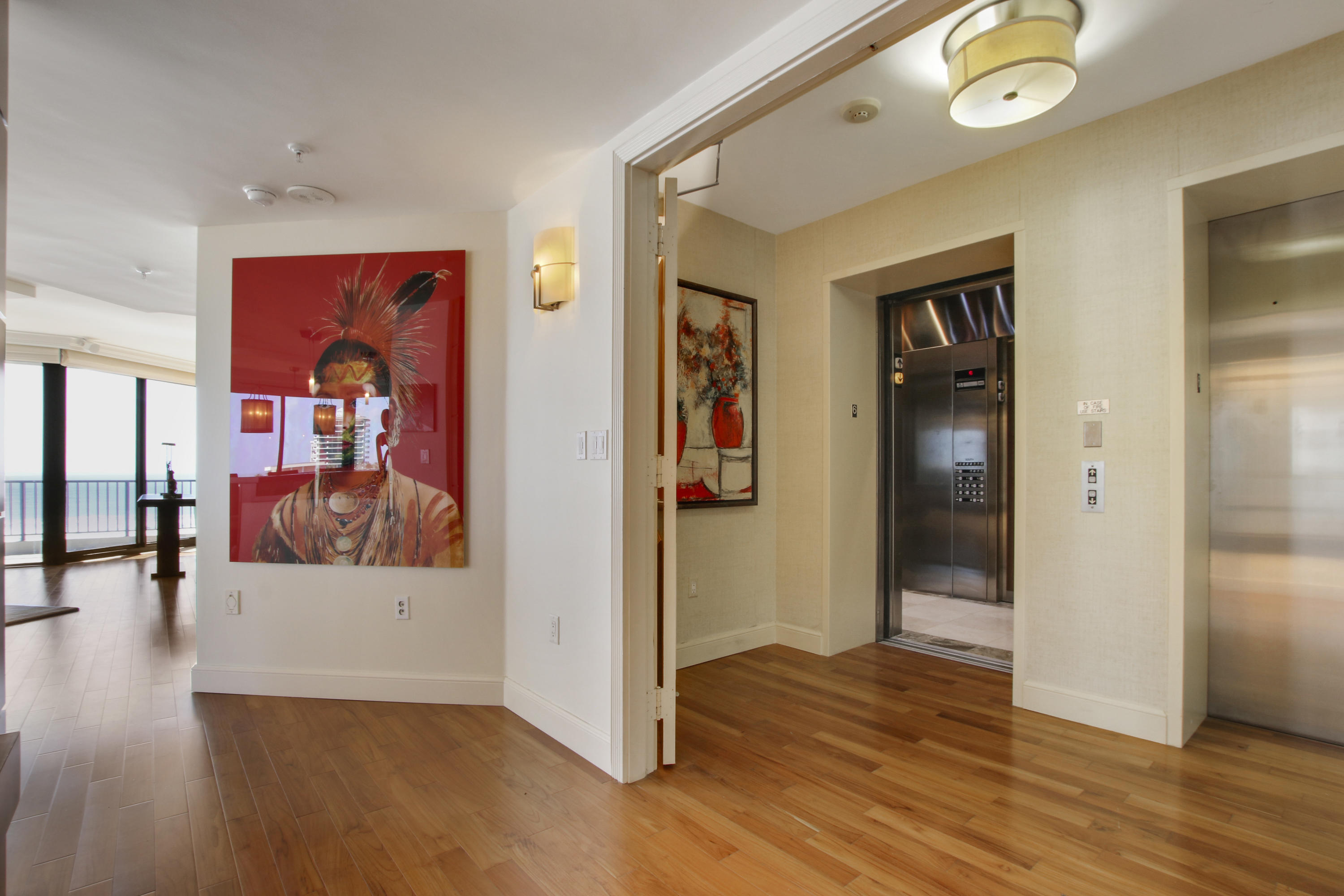 570 Ocean Drive, Unit 601 Juno Beach, FL 33408 - Photo 6 of 35 a view of a hallway with wooden floor and dining room