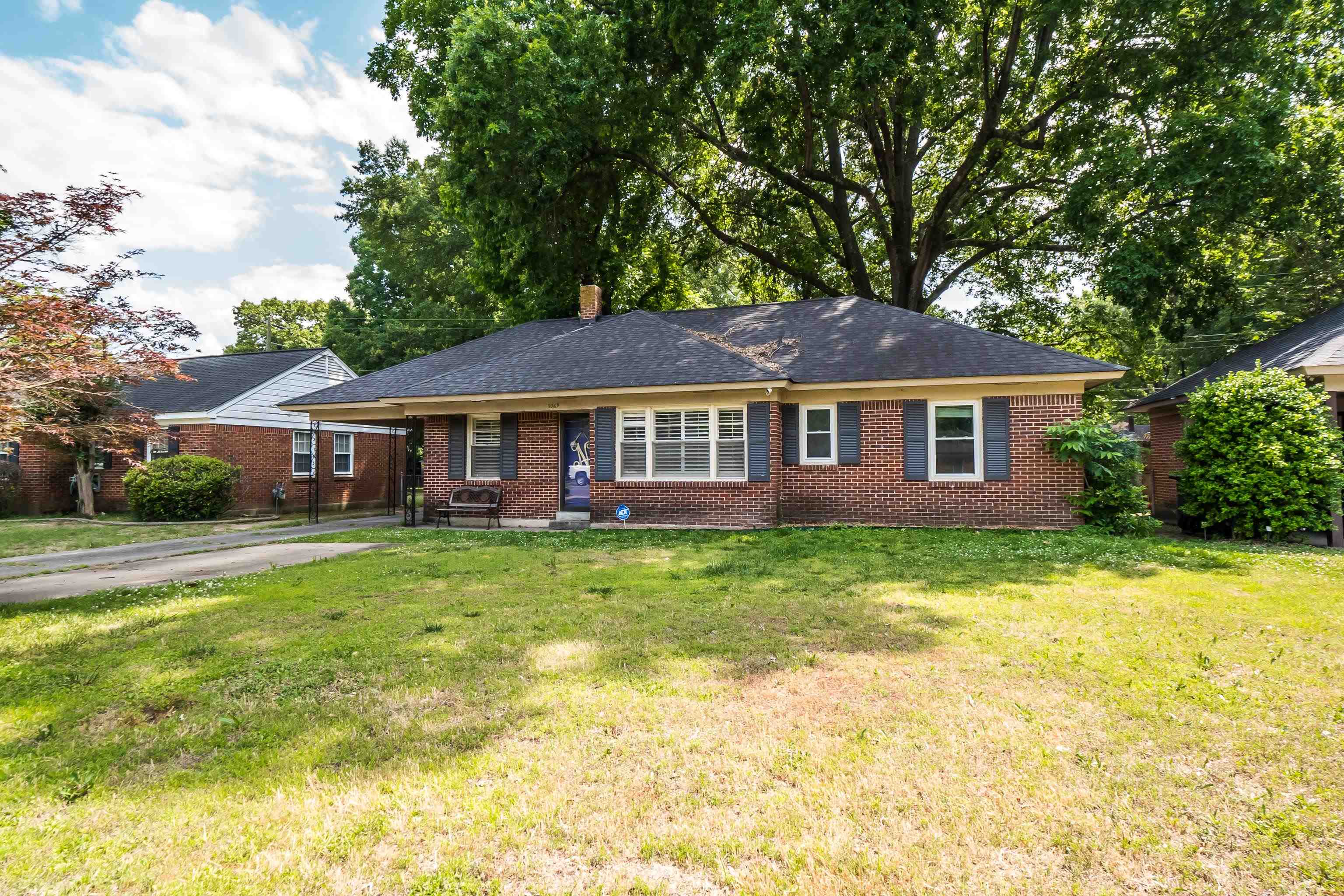 5069 Quince Road Memphis, TN 38117 - Photo 1 of 25 a front view of a house with a yard