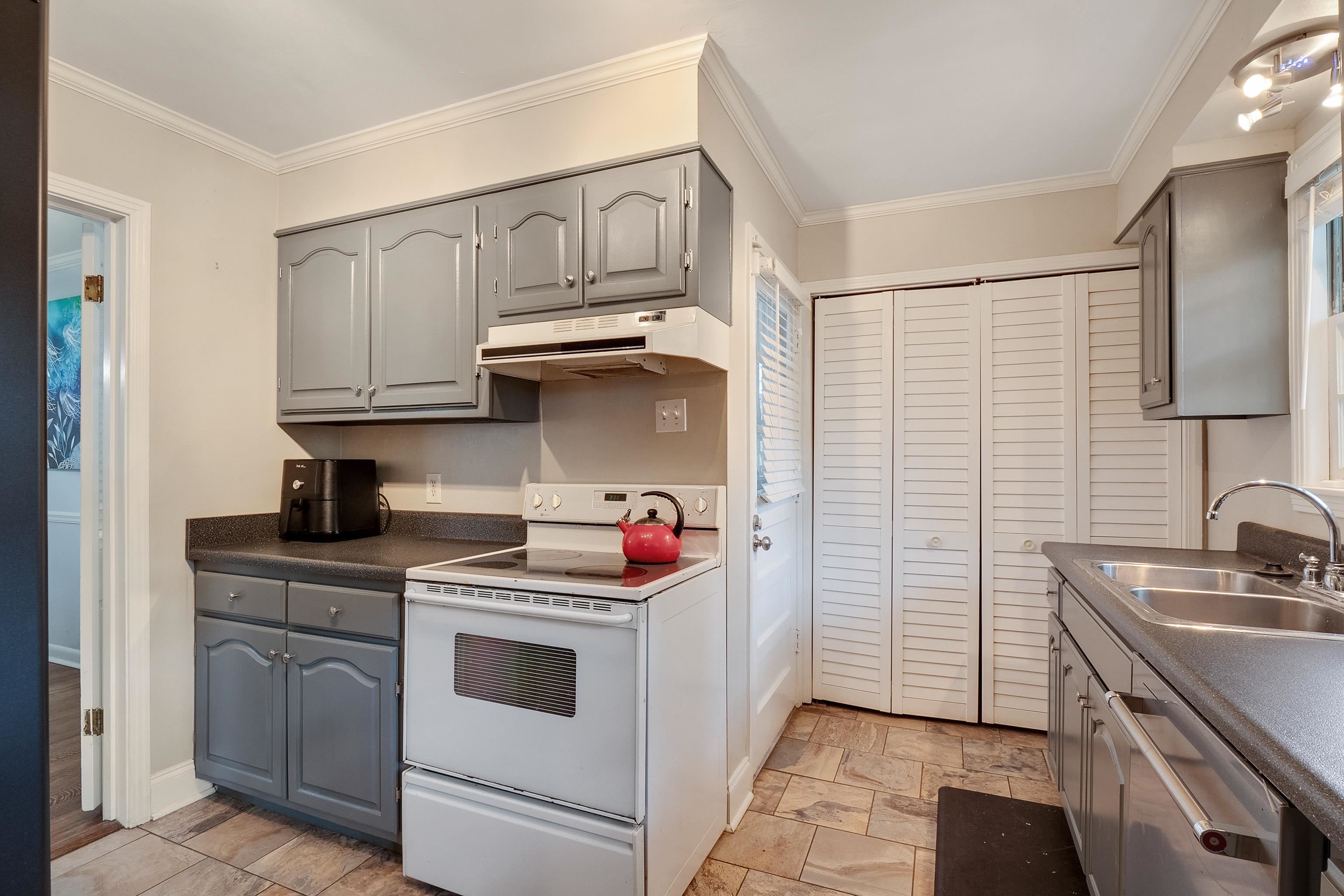 5069 Quince Road Memphis, TN 38117 - Photo 12 of 25 a kitchen with stainless steel appliances granite countertop a sink stove and cabinets