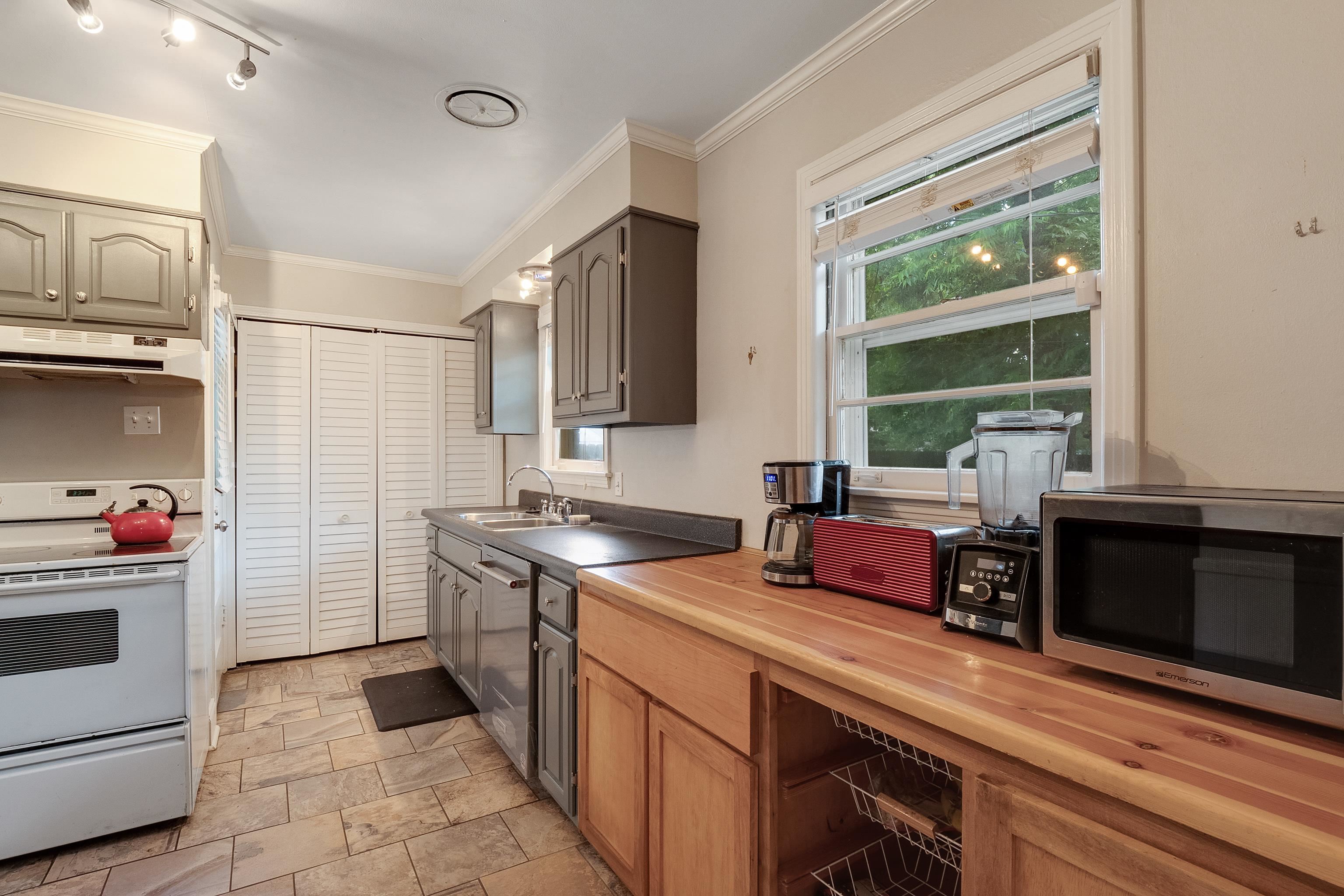 5069 Quince Road Memphis, TN 38117 - Photo 13 of 25 a kitchen with a sink stove and cabinets