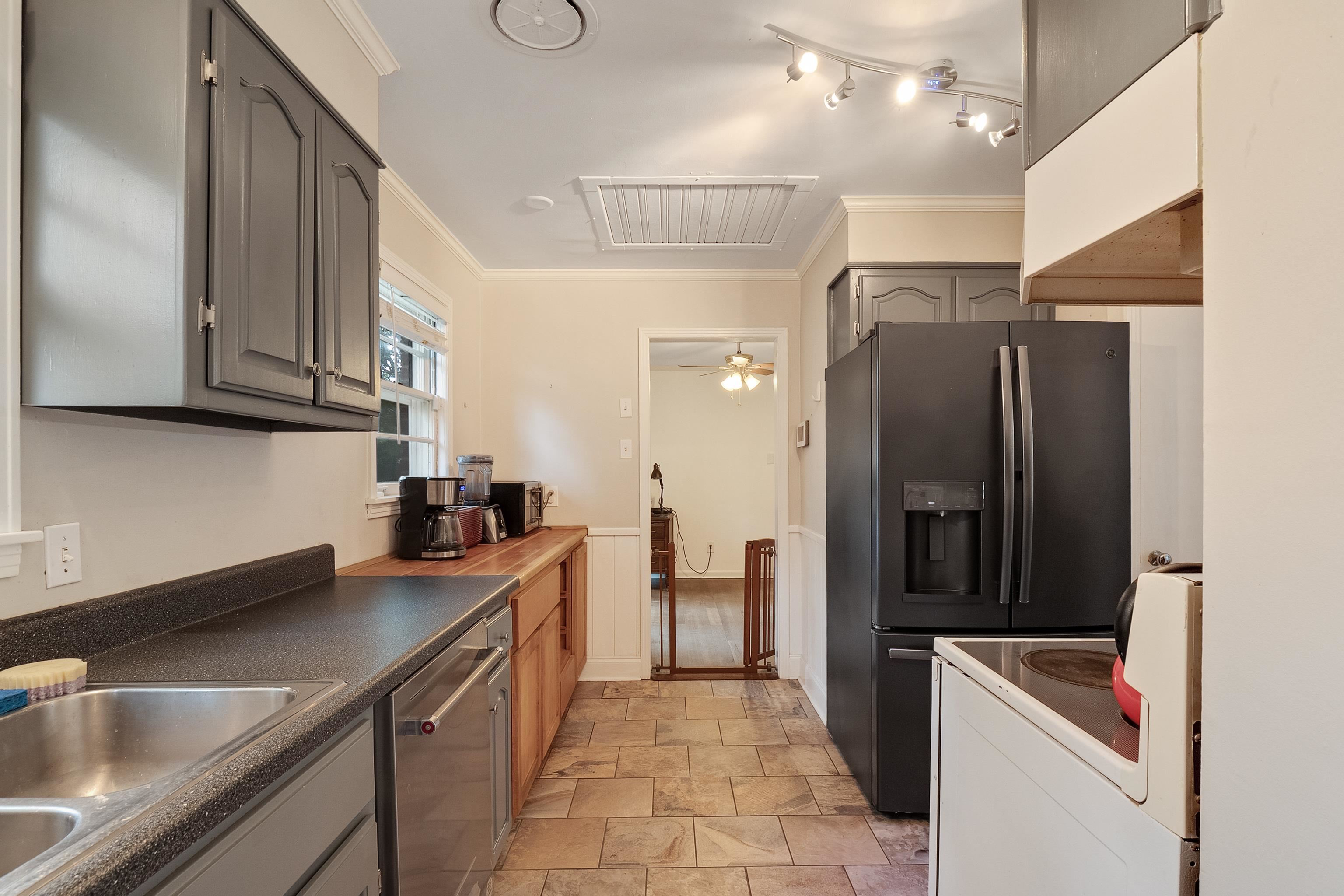 5069 Quince Road Memphis, TN 38117 - Photo 14 of 25 a kitchen that has a sink a refrigerator and cabinets