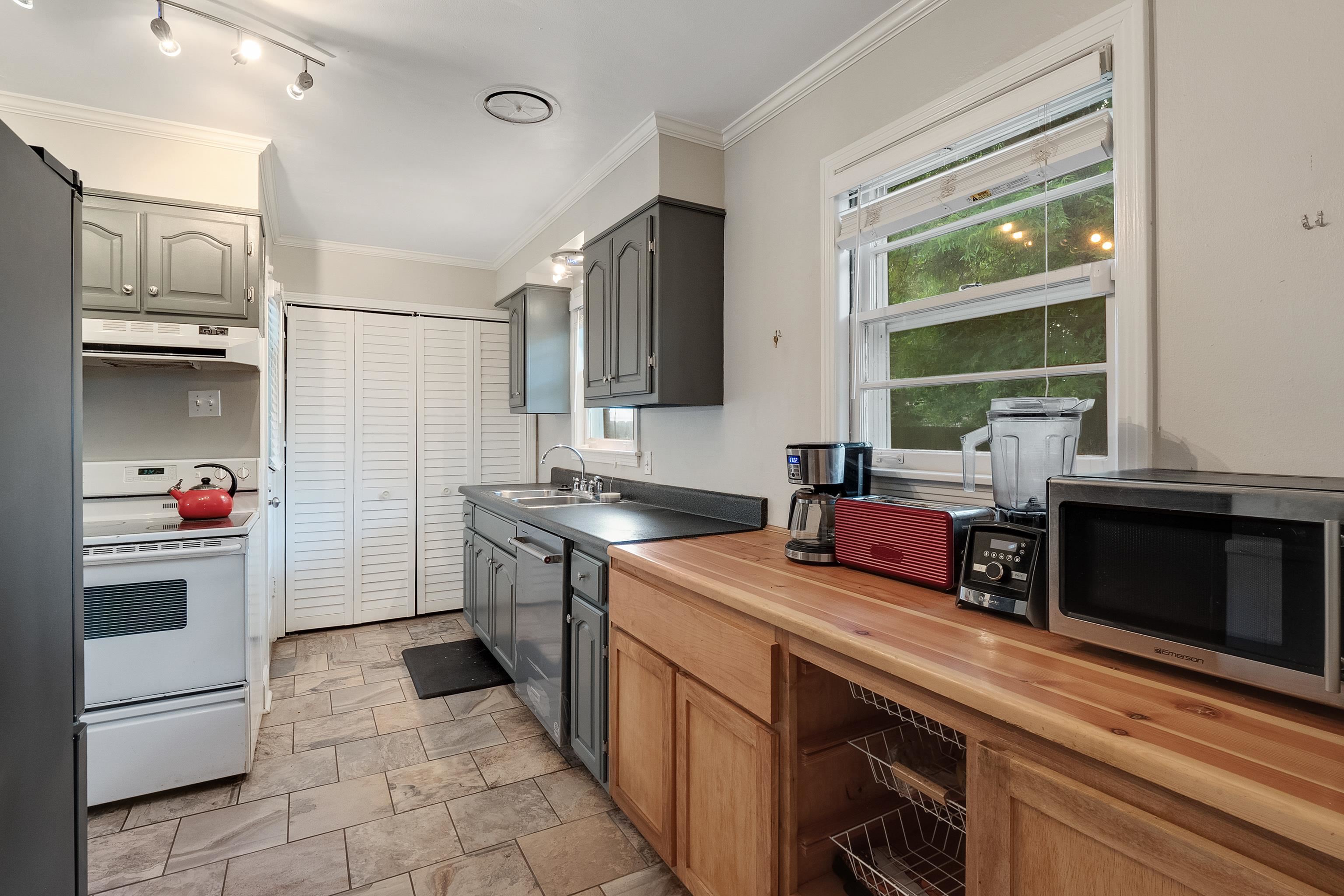 5069 Quince Road Memphis, TN 38117 - Photo 15 of 25 a kitchen with a sink cabinets and stainless steel appliances