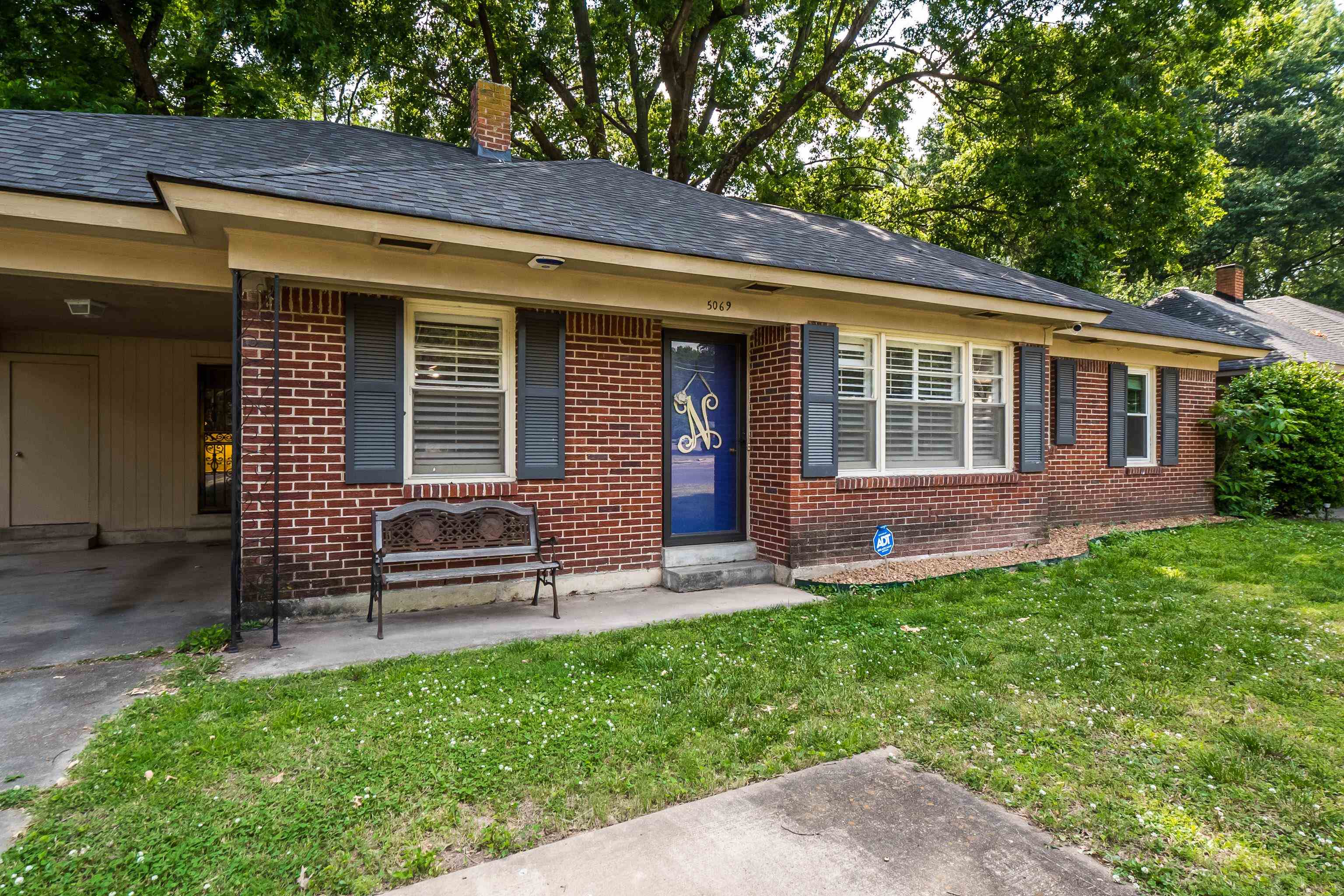 5069 Quince Road Memphis, TN 38117 - Photo 2 of 25 a front view of a house with a garden
