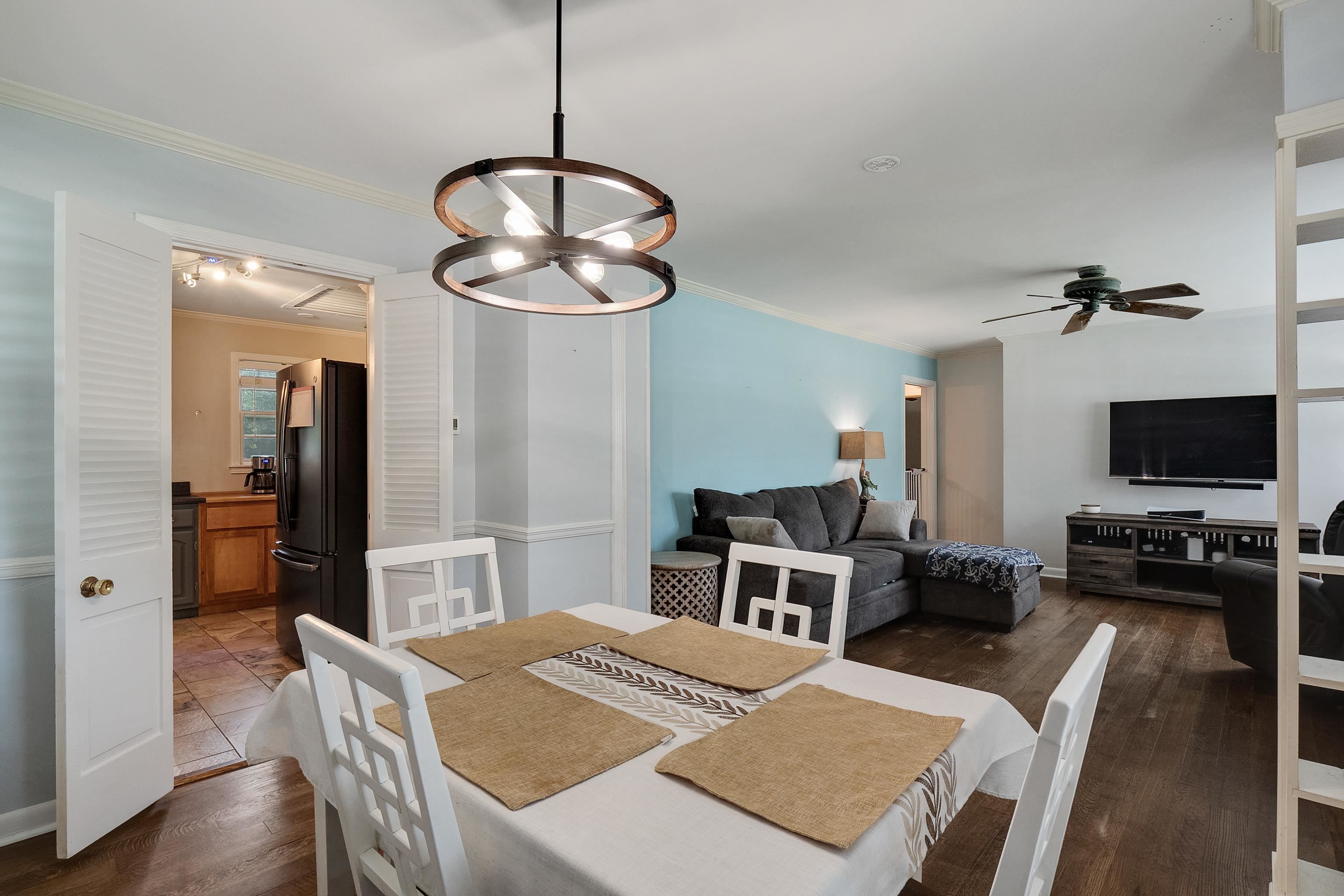 5069 Quince Road Memphis, TN 38117 - Photo 9 of 25 a view of a dining room with furniture a chandelier and wooden floor