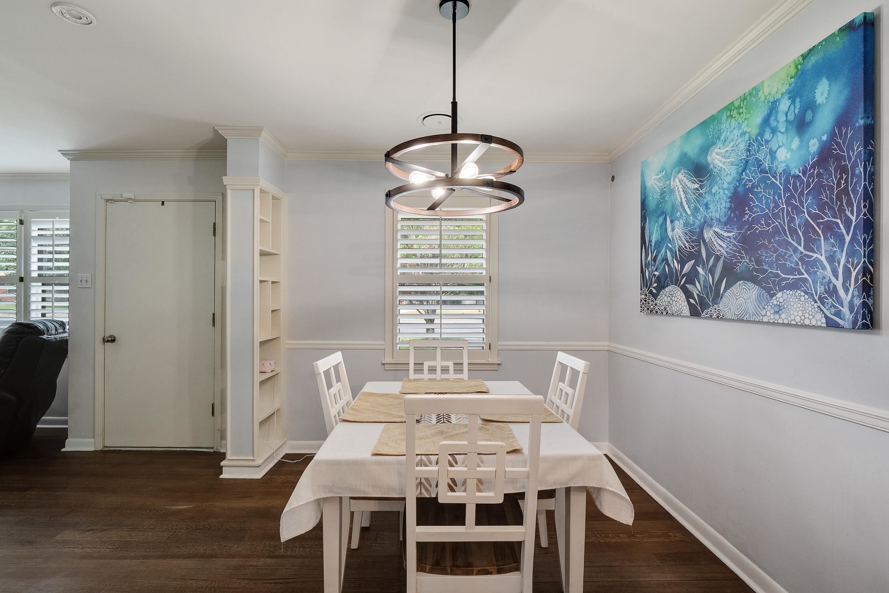 5069 Quince Road Memphis, TN 38117 - Photo 10 of 25 a view of a dining room with furniture wooden floor and a chandelier