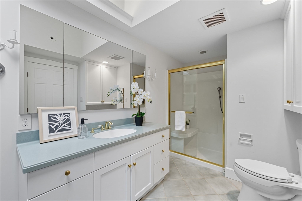 22 Burlington Street Lexington, MA 02420 - Photo 21 of 32 a spacious bathroom with a granite countertop sink a toilet a shower and a mirror
