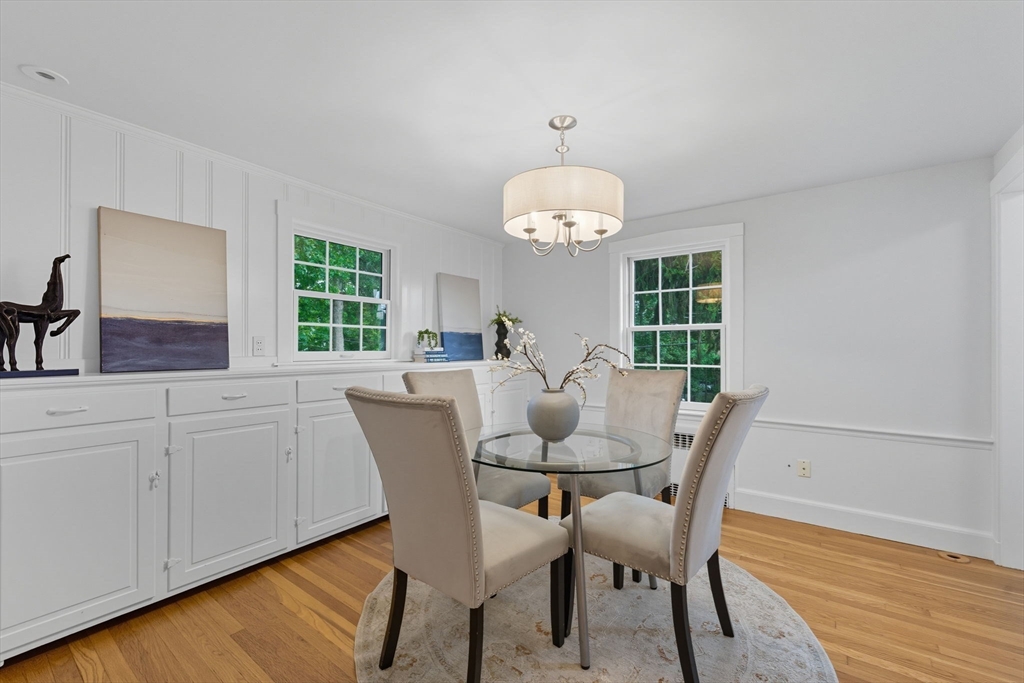 22 Burlington Street Lexington, MA 02420 - Photo 22 of 32 a view of a dining room with furniture a chandelier and wooden floor