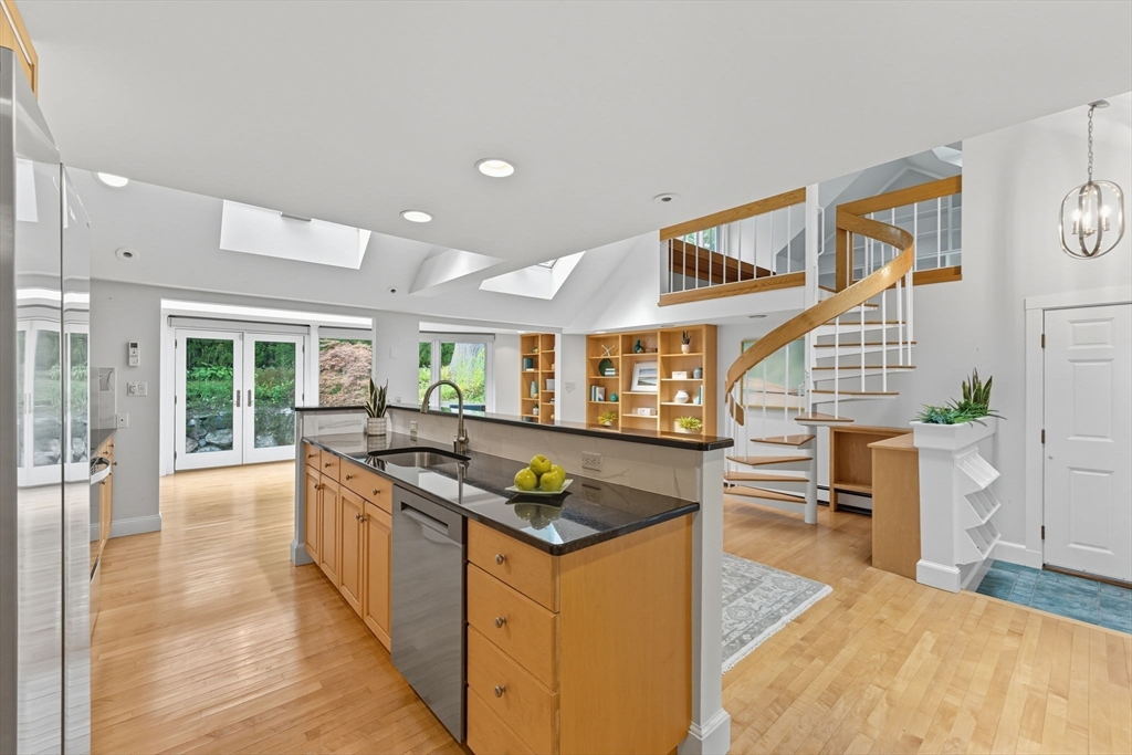 22 Burlington Street Lexington, MA 02420 - Photo 4 of 32 a kitchen with stainless steel appliances granite countertop a stove and a sink