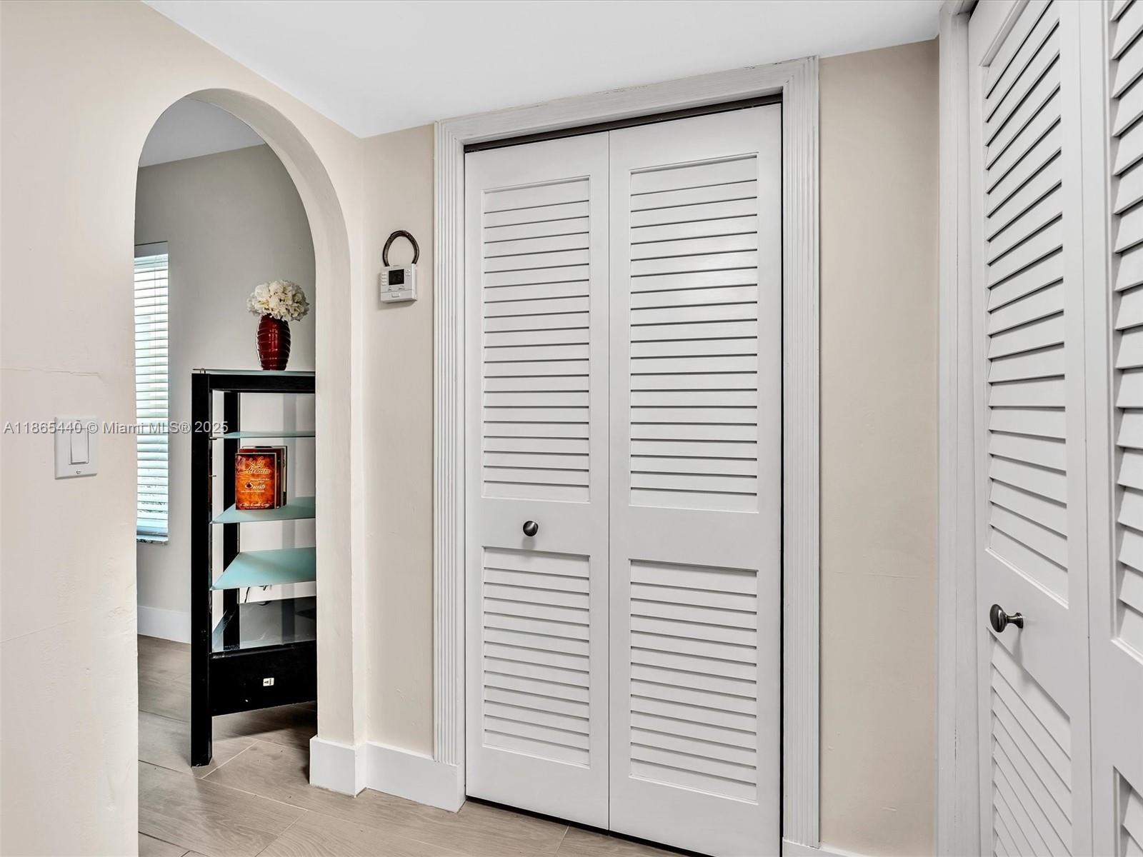301 Sunrise Drive, Unit 1DW Key Biscayne, FL 33149 - Photo 11 of 40 a view of a hallway with closet and a window