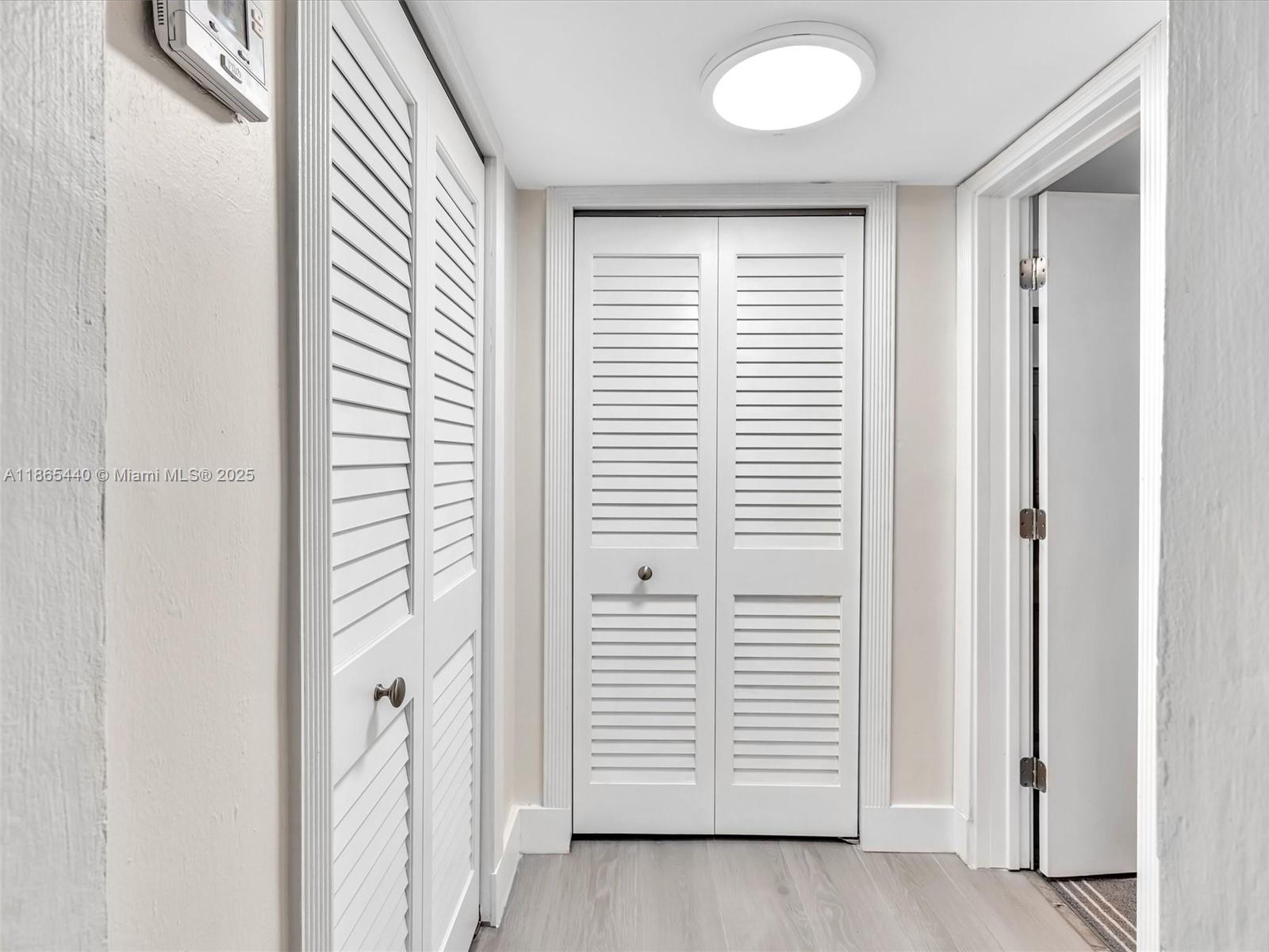 301 Sunrise Drive, Unit 1DW Key Biscayne, FL 33149 - Photo 12 of 40 a view of a hallway with closet area