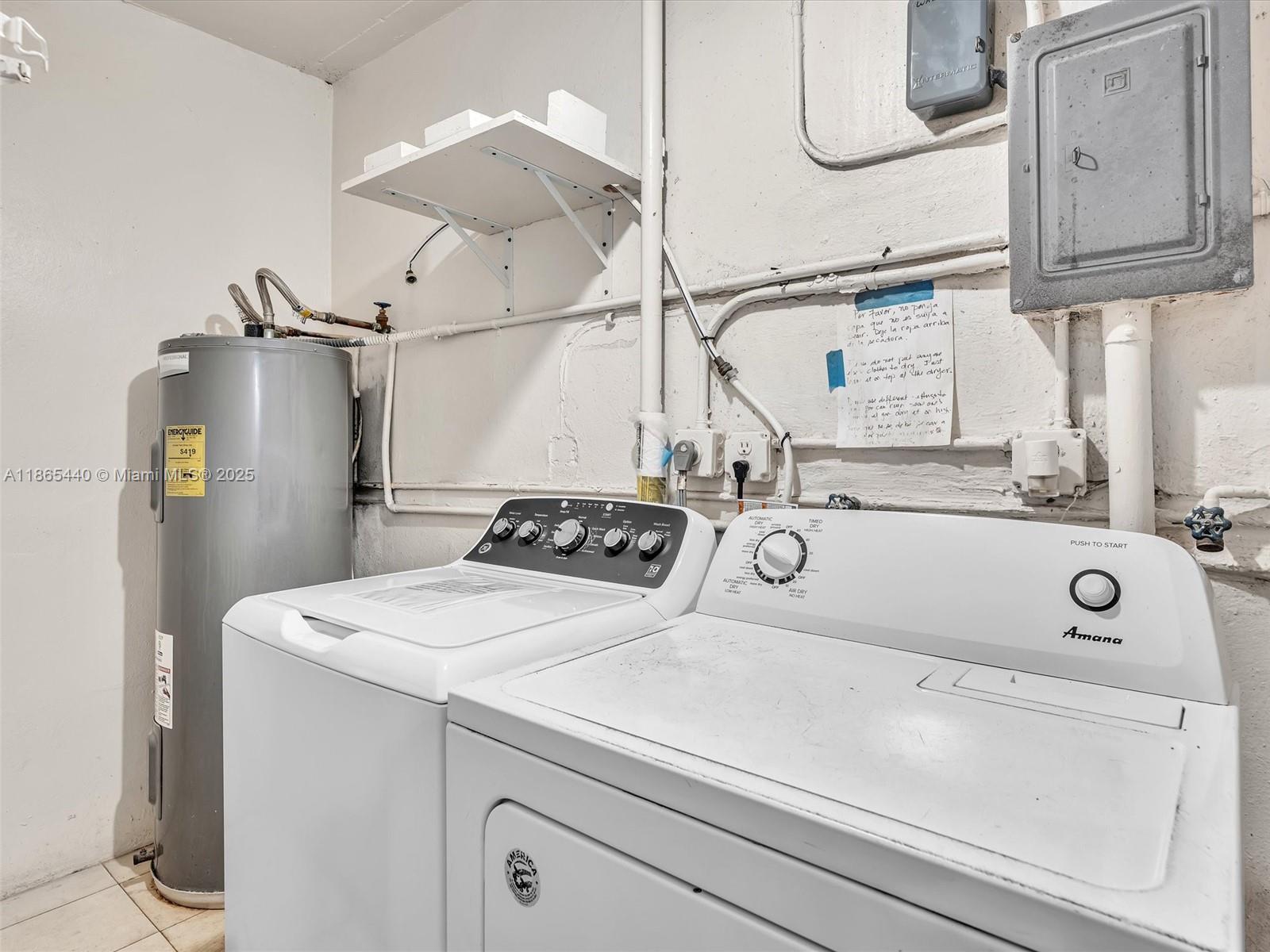 301 Sunrise Drive, Unit 1DW Key Biscayne, FL 33149 - Photo 17 of 40 a utility room with dryer and washer