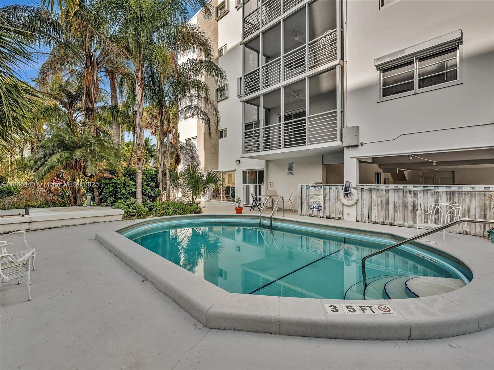 301 Sunrise Drive, Unit 1DW Key Biscayne, FL 33149 - Photo 3 of 40 a view of swimming pool with outdoor seating
