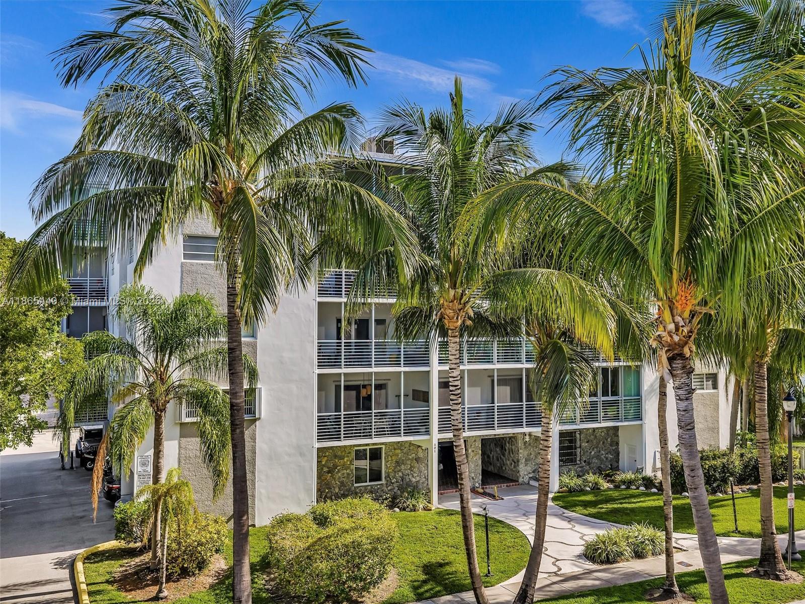 301 Sunrise Drive, Unit 1DW Key Biscayne, FL 33149 - Photo 31 of 40 a view of a palm tree with a backyard