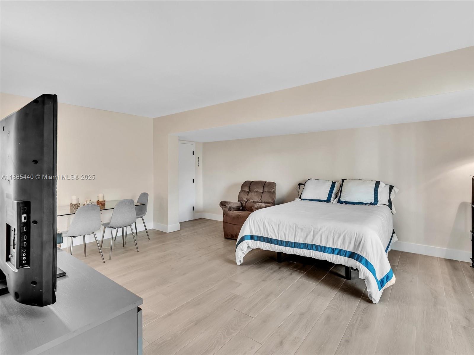 301 Sunrise Drive, Unit 1DW Key Biscayne, FL 33149 - Photo 9 of 40 a bedroom with furniture and a table