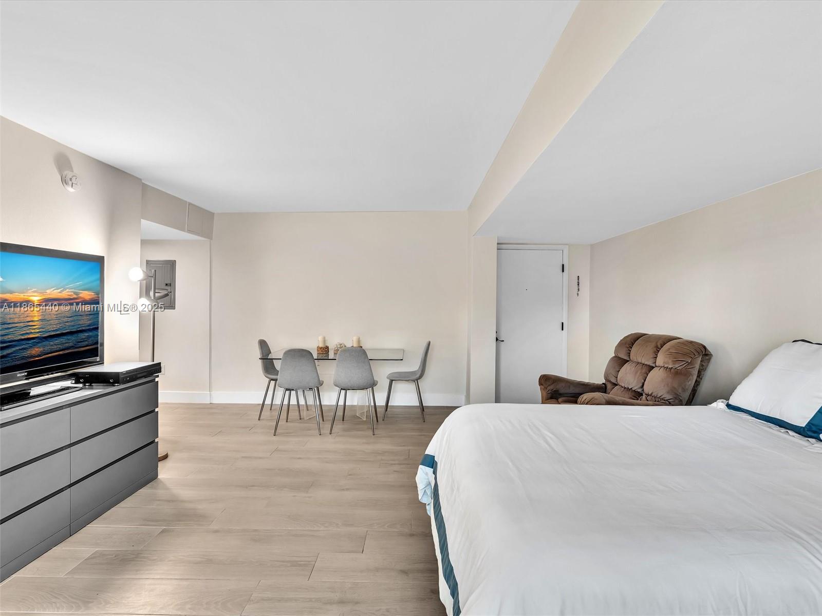 301 Sunrise Drive, Unit 1DW Key Biscayne, FL 33149 - Photo 10 of 40 a bedroom with a bed and a flat screen tv