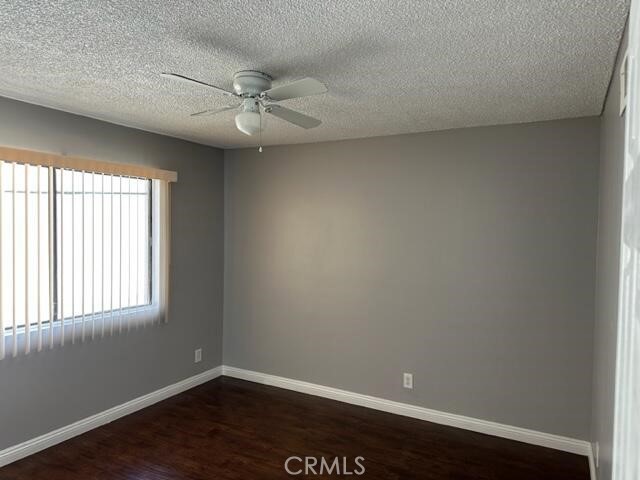 16115 3/4 Eucalyptus Avenue, Unit A Bellflower, CA 90706 - Photo 12 of 17 an empty room with wooden floor and windows