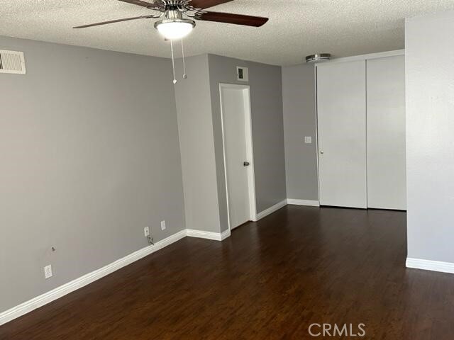 16115 3/4 Eucalyptus Avenue, Unit A Bellflower, CA 90706 - Photo 9 of 17 an empty room with wooden floor and fan