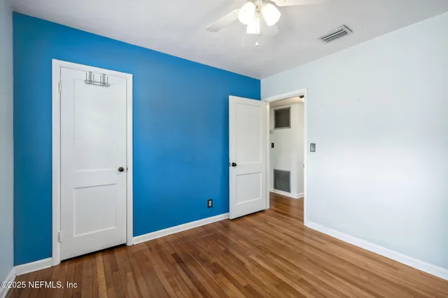 a view of an empty room with a fireplace and a window
