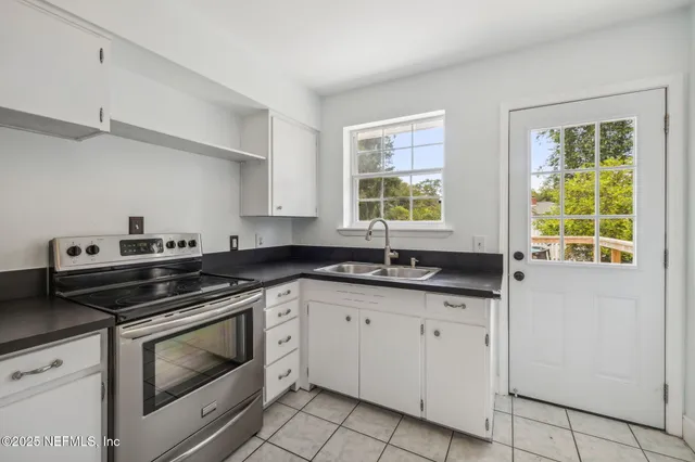 a view of a kitchen with granite countertop cabinets and black appliances