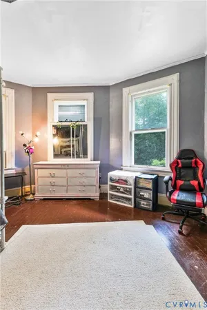 a bedroom with furniture and a large window