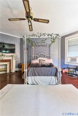 a bedroom with a bed window and couch