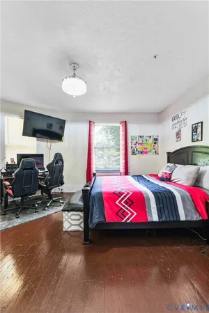 a bedroom with a bed and a chandelier
