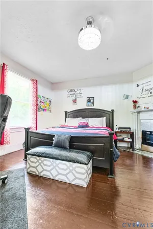 a bedroom with furniture and a wooden floor