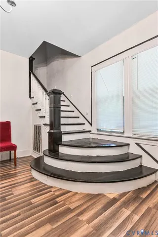 a view of entryway and hall with wooden floor