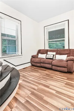 a living room with couches and a large window with outer view