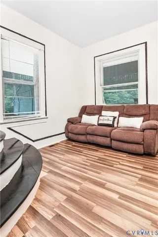 a living room with couches and a large window with outer view