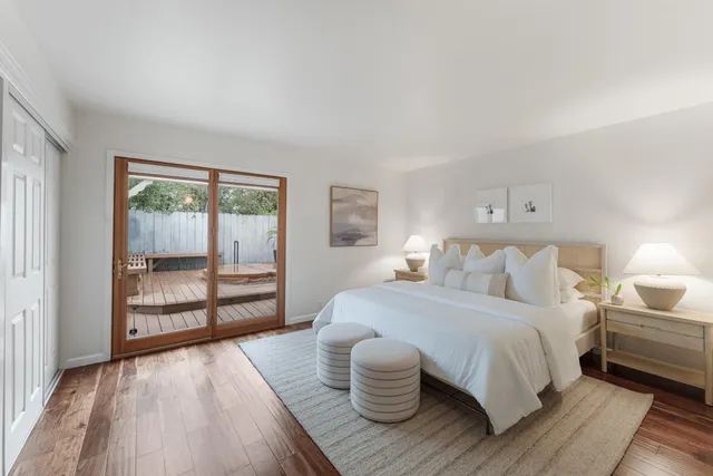 a bedroom with a bed and a large window