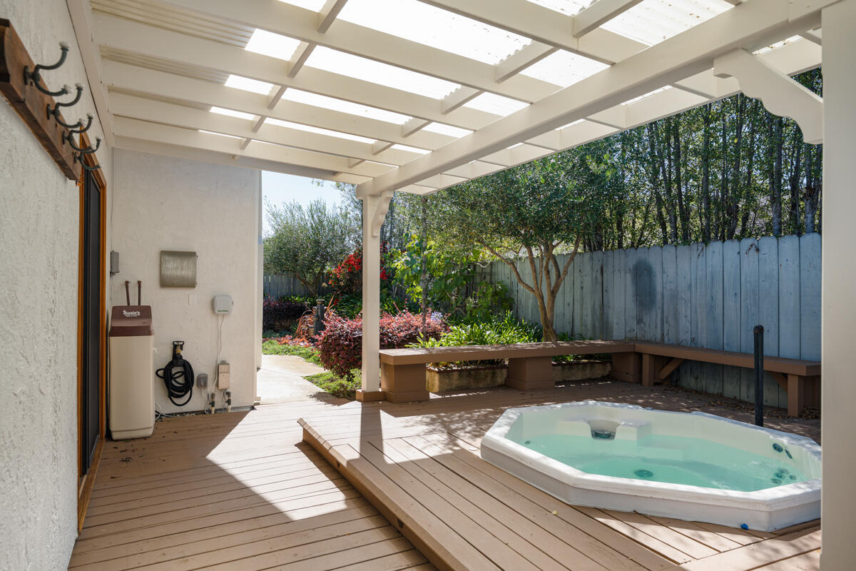 1436 Carnation Place Carpinteria, CA 93013 - Photo 17 of 32 a view of a backyard with table and chairs potted plants with wooden floor and fence